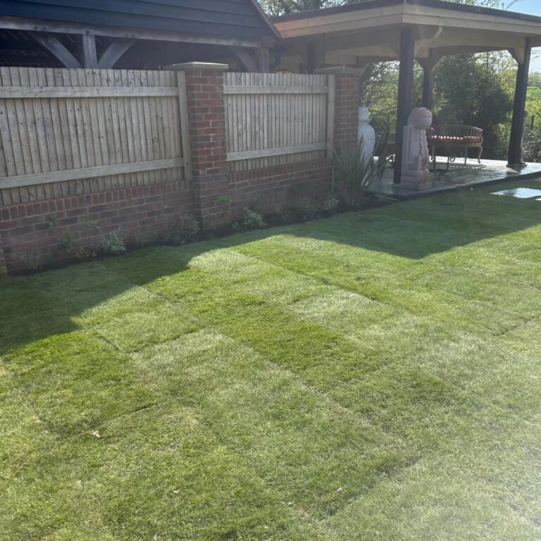 Freshly turfed lawn in Lenham with sandstone path and paving stones near the house