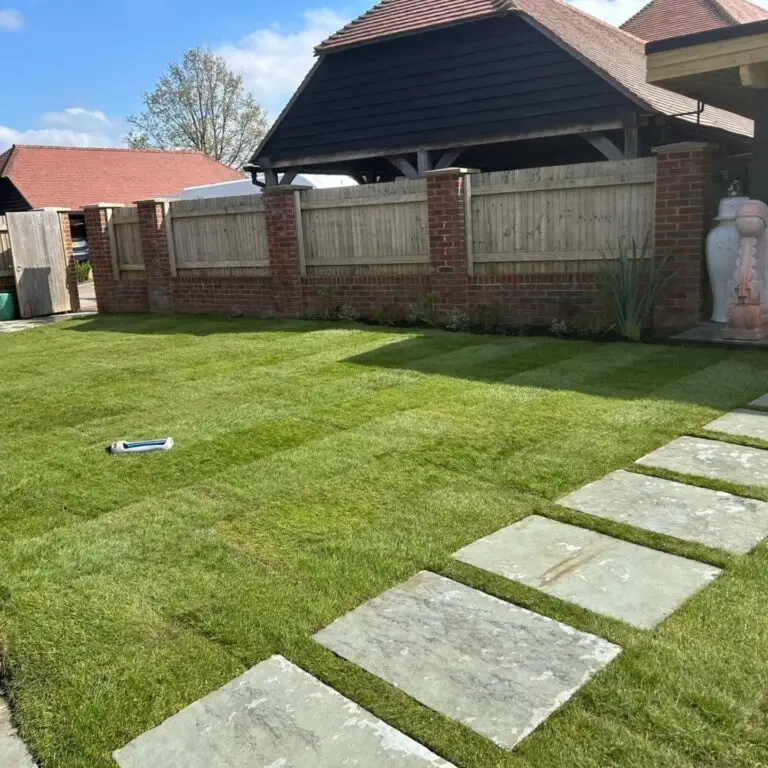 Garden lawn in Lenham with fresh turf and sandstone stepping stones leading across the lawn