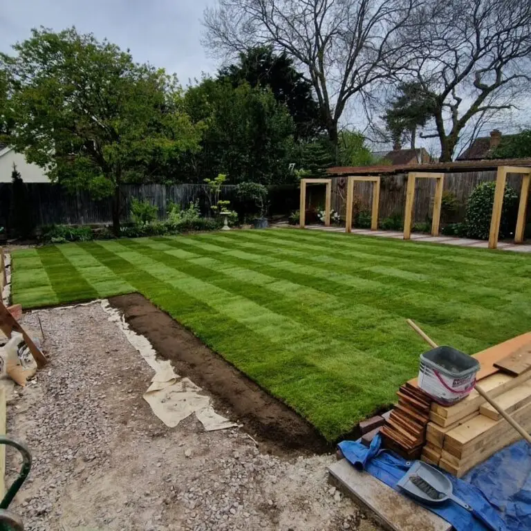 Completed premium turf installation in Bearsted featuring lush green lawn and landscaped garden beds.