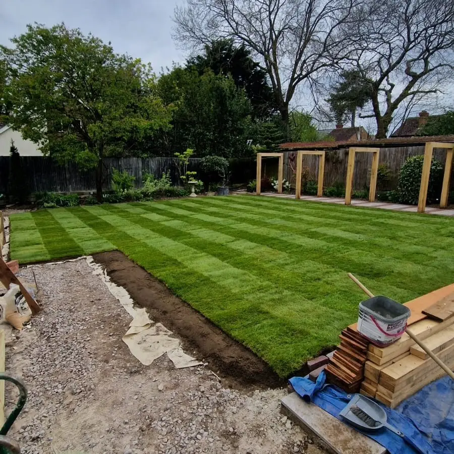 Completed premium turf installation in Bearsted featuring lush green lawn and landscaped garden beds.